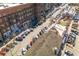 Aerial view of a busy street with retail shops and outdoor seating areas, showcasing urban living at 219 Dawson Dr, Woodstock, GA 30188