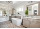 Bright bathroom features double vanity, soaking tub, and large arched mirror at 219 Dawson Dr, Woodstock, GA 30188