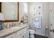 Well-lit half bathroom with patterned floor tiles, decorative decor, and luxurious countertops at 219 Dawson Dr, Woodstock, GA 30188