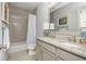 Bathroom with double vanity, shower with tub, and neutral color palette at 219 Dawson Dr, Woodstock, GA 30188