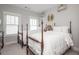 Bedroom featuring two beds, ample natural light, and decorative crown accents at 219 Dawson Dr, Woodstock, GA 30188