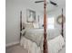 Bedroom with a four-poster bed, neutral tones, and stylish decor at 219 Dawson Dr, Woodstock, GA 30188