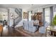 Elegant dining room with hardwood floors, stylish rug, chairs, lighting, and adjacent staircase at 219 Dawson Dr, Woodstock, GA 30188