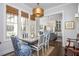 Charming dining room features a modern table setting with stylish chairs, natural light, and an open view to the kitchen at 219 Dawson Dr, Woodstock, GA 30188