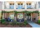 Charming brick front porch adorned with greenery, inviting seating, and double doors, adding curb appeal at 219 Dawson Dr, Woodstock, GA 30188