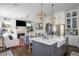 Modern kitchen with a breakfast bar overlooking the living room and fireplace at 219 Dawson Dr, Woodstock, GA 30188