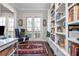 Inviting office space with custom built-in shelving, desk, chair, and French doors at 219 Dawson Dr, Woodstock, GA 30188