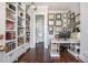 Bright home office with built-in shelves leading to a half bathroom. Filled with natural light at 219 Dawson Dr, Woodstock, GA 30188