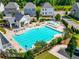 Aerial view of the community pool with sun loungers, covered seating areas, and landscaped surroundings at 219 Dawson Dr, Woodstock, GA 30188