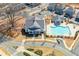 Aerial view of community pool, clubhouse, and pool house surrounded by walking trails and green space at 219 Dawson Dr, Woodstock, GA 30188