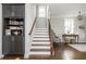 Bright staircase with hardwood floors, custom built-ins, and natural light at 219 Dawson Dr, Woodstock, GA 30188