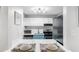 Well-lit kitchen with stainless steel appliances, white cabinets, and a breakfast bar at 2707 Cumberland Se Ct, Smyrna, GA 30080