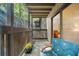 Inviting covered patio with comfortable blue chairs and views of mature trees at 2707 Cumberland Se Ct, Smyrna, GA 30080