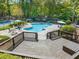 Inviting pool and tennis courts with lounge chairs and an outdoor grilling area on deck overlooking the pool at 2707 Cumberland Se Ct, Smyrna, GA 30080