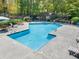 Relaxing community pool area with several lounge chairs and a nearby covered grilling area at 2707 Cumberland Se Ct, Smyrna, GA 30080