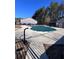 Community pool closed for the winter; covered with a tarp, surrounded by a patio, set in a wooded environment at 3852 Woodridge Way, Tucker, GA 30084