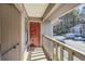 View of a covered porch area with a red door and view of the parking area and surrounding buildings at 3852 Woodridge Way, Tucker, GA 30084