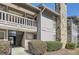 Exterior view showcasing the entrance to a multi-story condo building and landscaped foliage at 3852 Woodridge Way, Tucker, GA 30084