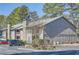 Exterior view of a multi-story building with stone and siding and parking at 3852 Woodridge Way, Tucker, GA 30084