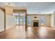 An open floor plan living room with hardwood floors, a fireplace and large windows at 3852 Woodridge Way, Tucker, GA 30084