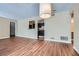 Living room view showcasing wood flooring and an opening looking into the kitchen area at 3852 Woodridge Way, Tucker, GA 30084