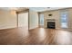 Living room featuring wood floors, fireplace, modern light fixture, and plenty of natural light at 3852 Woodridge Way, Tucker, GA 30084