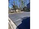 An empty section of parking lot with painted parking lines and some landscaping at 3852 Woodridge Way, Tucker, GA 30084