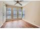 Bright sunroom featuring wood floors, multiple windows, and lots of natural light at 3852 Woodridge Way, Tucker, GA 30084