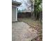 A backyard with stone patio, wooden fence, mature tree, and siding on the house at 409 Inman Sw St, Atlanta, GA 30310
