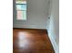 This bedroom features hardwood floors, a window, and white walls at 409 Inman Sw St, Atlanta, GA 30310