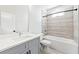 Modern bathroom with gray vanity, tub, and tiled shower at 622 Bellemeade Nw Ave # 4, Atlanta, GA 30318