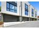 Street view of modern townhomes featuring sleek dark garage doors and stylish facade at 622 Bellemeade Nw Ave # 4, Atlanta, GA 30318