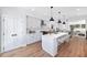 Modern kitchen featuring white cabinets, a large island with seating, and stainless steel appliances at 622 Bellemeade Nw Ave # 4, Atlanta, GA 30318