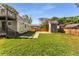 Spacious backyard featuring lush green grass, shed, and privacy fence at 1471 Hardin Ave, College Park, GA 30337