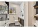 Stylish bathroom featuring geometric tile, black hardware, glass shower door, and modern vanity at 1471 Hardin Ave, College Park, GA 30337