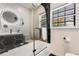 Modern bathroom features geometric tile, black hardware, glass shower door, and vanity at 1471 Hardin Ave, College Park, GA 30337