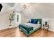 Cozy bedroom features wood floors, a chandelier, and sloped ceilings at 1471 Hardin Ave, College Park, GA 30337