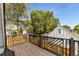 Lovely wooden deck with black iron railings overlooking a beautiful backyard and mature trees at 1471 Hardin Ave, College Park, GA 30337