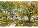 Beautiful home with a large tree, a brick walkway and healthy green grass at 1471 Hardin Ave, College Park, GA 30337