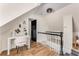 Cozy loft area with a small desk, chair, and stairs, plus an interesting light fixture overhead at 1471 Hardin Ave, College Park, GA 30337