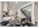 This kitchen eating area shows a black table and gray velvet chairs in front of updated kitchen appliances at 1471 Hardin Ave, College Park, GA 30337