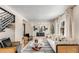 Bright and airy living room with modern furniture, hardwood floors, and neutral decor at 1471 Hardin Ave, College Park, GA 30337