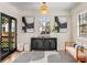 Bright living room features modern decor, stylish furnishings, and eye-catching art, plus a black metal-trimmed glass door at 1471 Hardin Ave, College Park, GA 30337