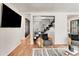 Stylish living room featuring modern decor, a sleek staircase, and a mounted TV at 1471 Hardin Ave, College Park, GA 30337