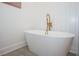 Modern freestanding bathtub with gold fixtures and floor to ceiling shiplap walls at 1667 Grace Se St, Atlanta, GA 30316