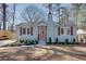 Charming home with a brick chimney, orange door, and well-manicured landscaping at 1667 Grace Se St, Atlanta, GA 30316