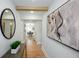 Stylish hallway with hardwood floors, decorative mirror, and artwork, leading to the living areas at 1667 Grace Se St, Atlanta, GA 30316