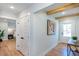 Hallway with hardwood floors and natural light, leading to bedrooms and an outdoor exit at 1667 Grace Se St, Atlanta, GA 30316