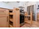 Kitchen area with stainless steel appliances, custom pull-out shelving and hardwood floors at 1667 Grace Se St, Atlanta, GA 30316