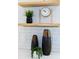 Staged kitchen featuring decorative vases, clock and small plants on wooden shelves at 1667 Grace Se St, Atlanta, GA 30316
